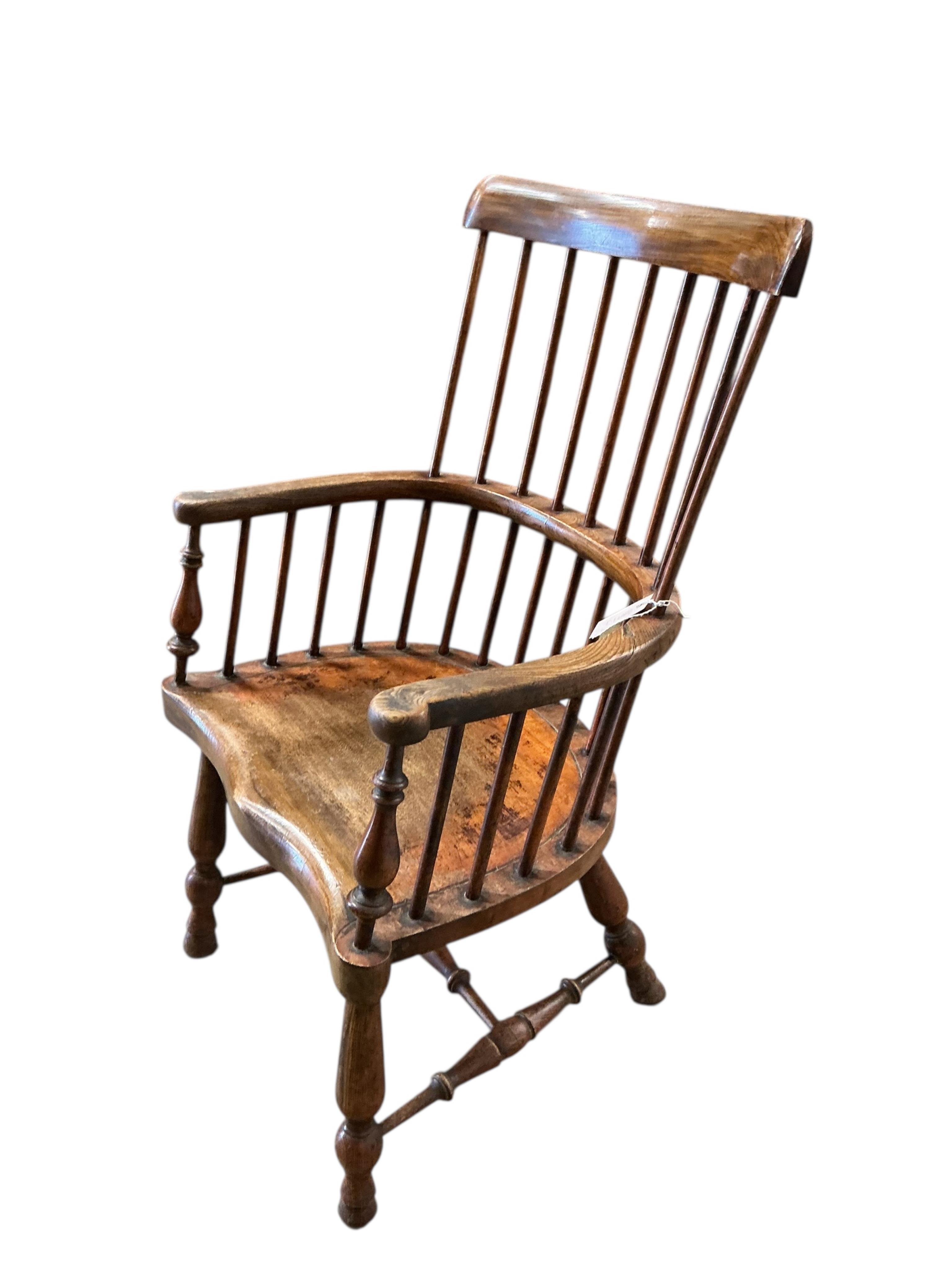 An early 20th century elm and beech Windsor comb back elbow chair, width 57cm, depth 42cm, height 95cm